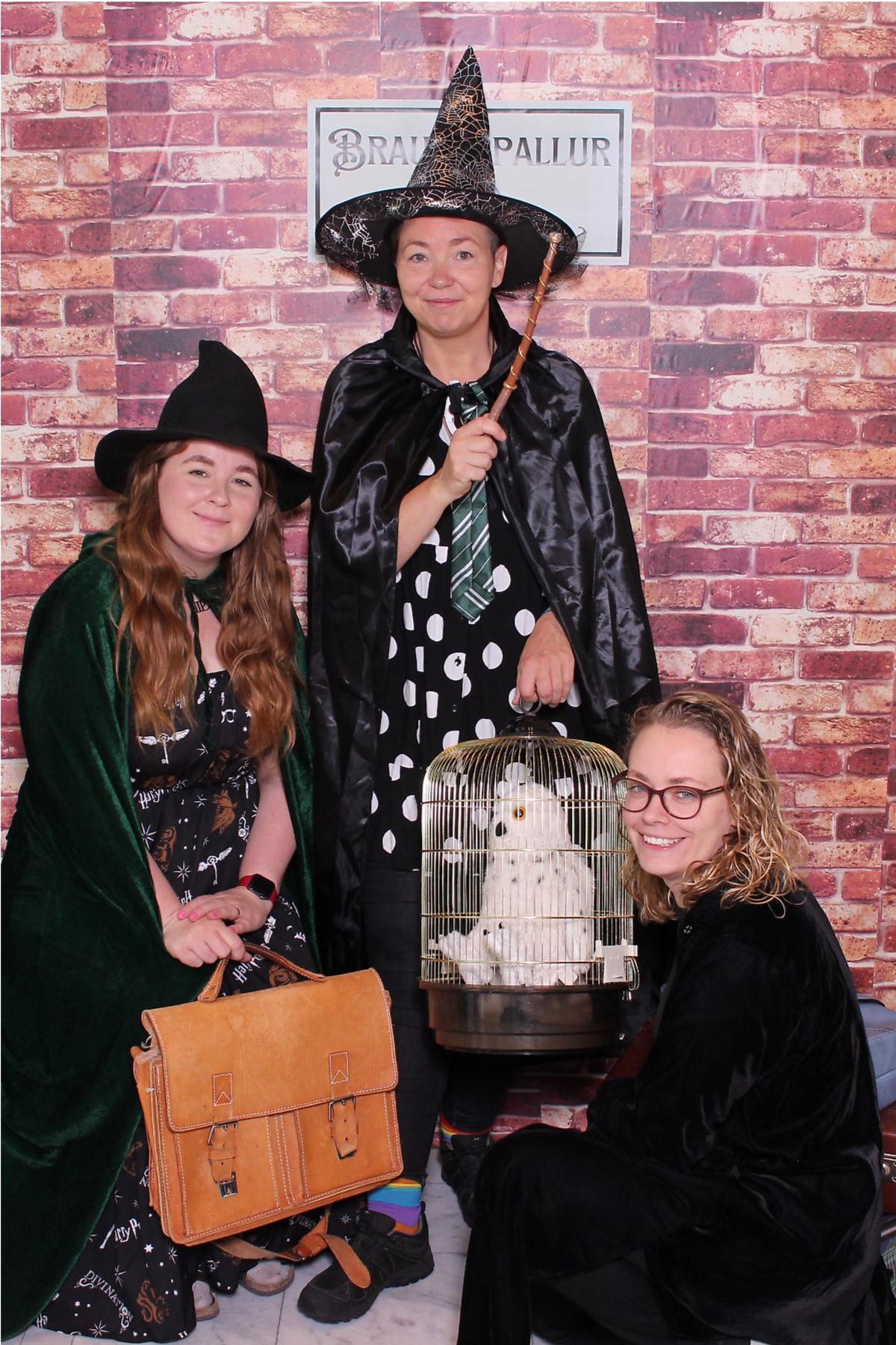 Three women dressed as witches posing for a picture