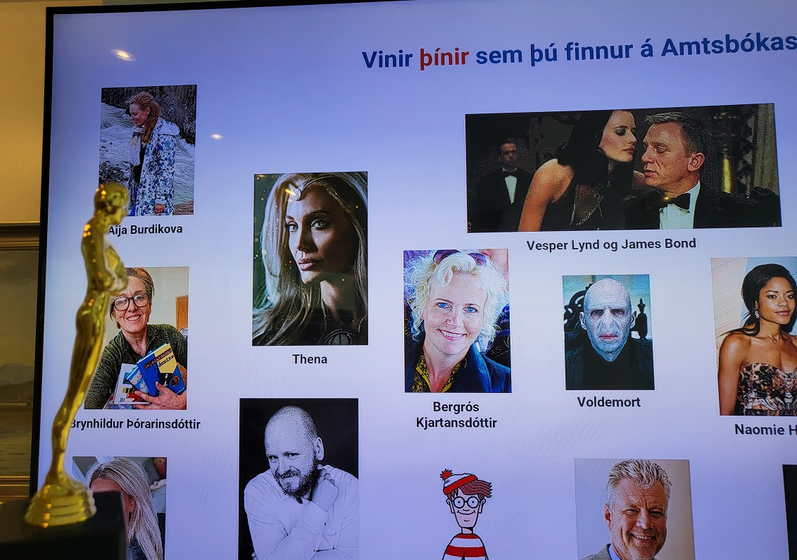 Óskarsstytta fyrir framan stóran skjá á vegg ...