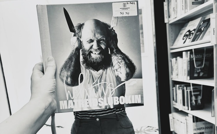 Picture of bookface taken with bookshelves in the background