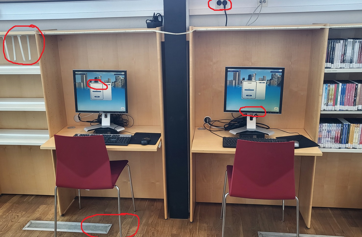 Two computers with keyboards and screens, two chairs and desks and shelves on the sides