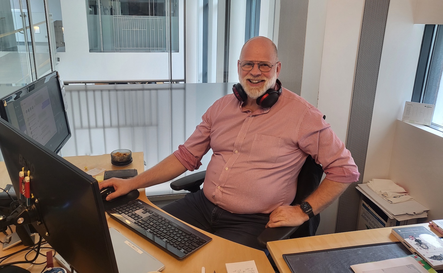 Man sitting behind a desk and in front of a computer