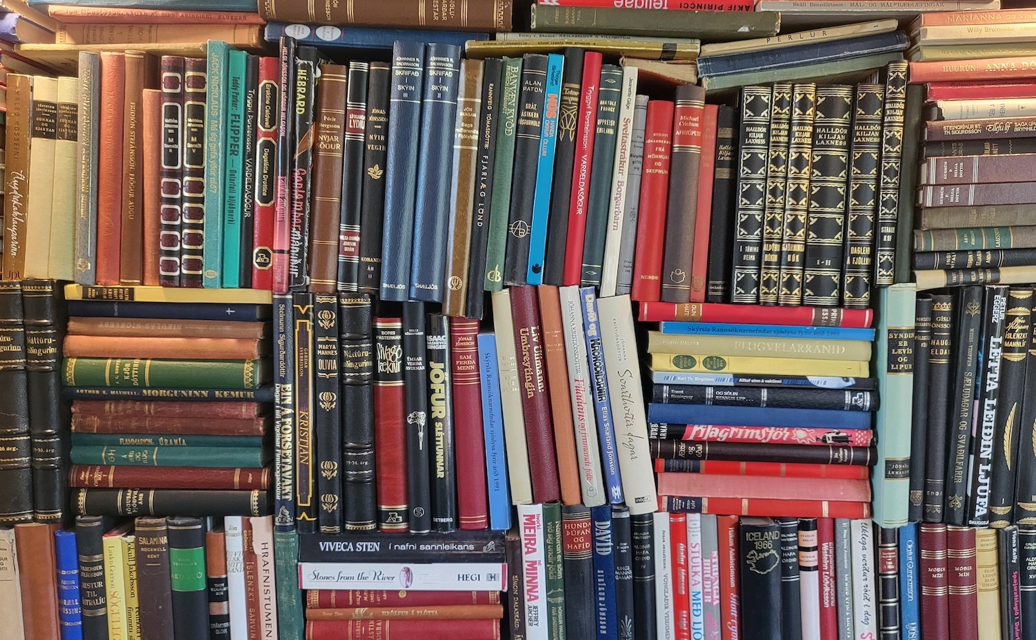Books and stacks of books against a wall