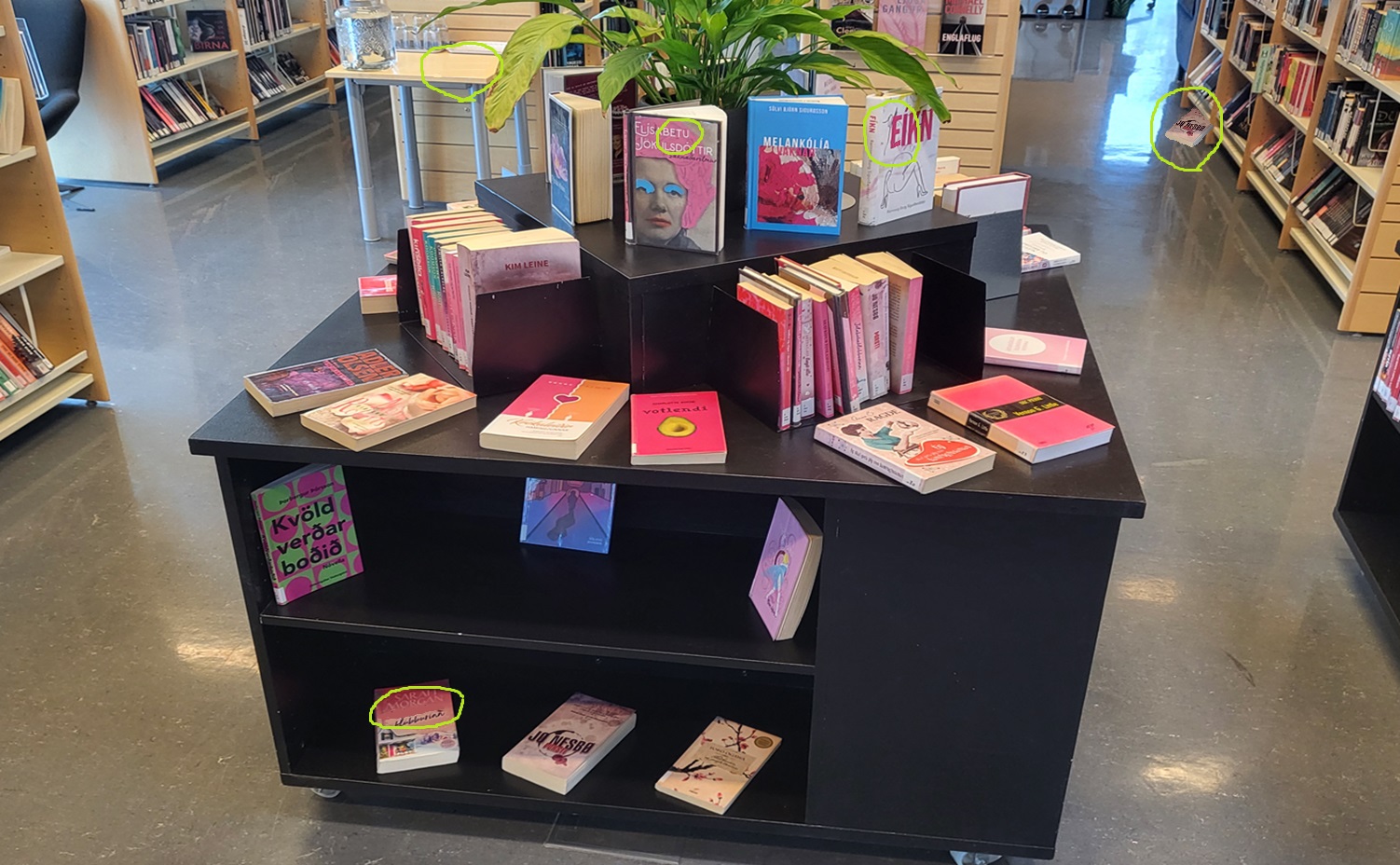 Exhibition table with pink-colored books on it