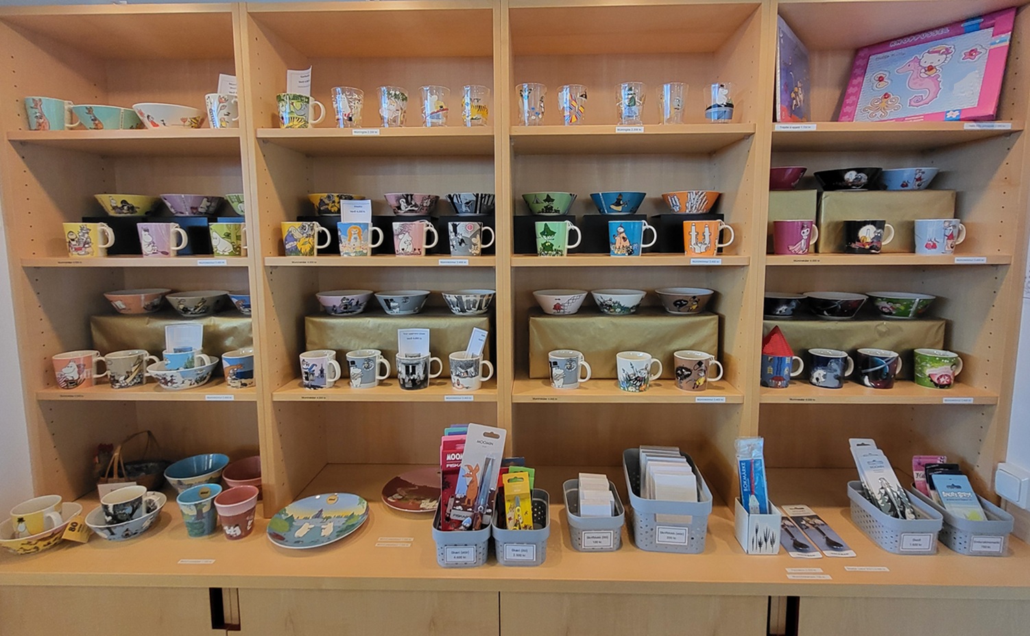 Picture of shelves filled with all kinds of products, mostly related to the Moomin figures