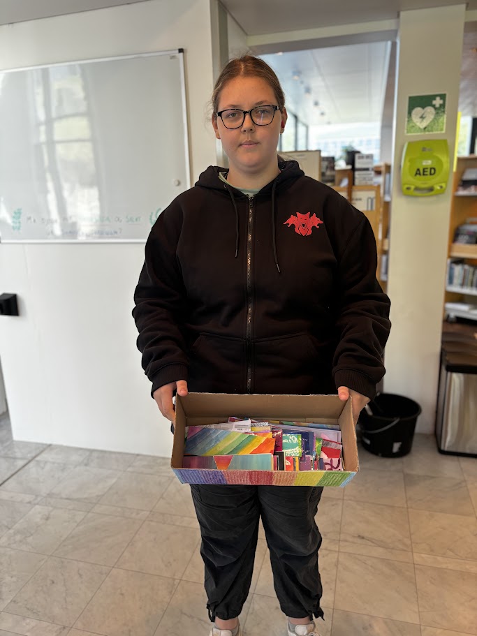 Young woman with a box of bookmarks